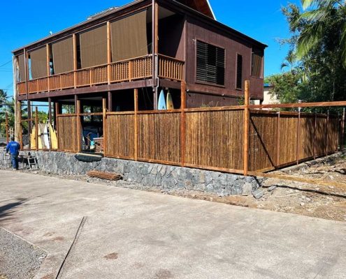 Bamboo fence installation around the perimeter of the backyard.