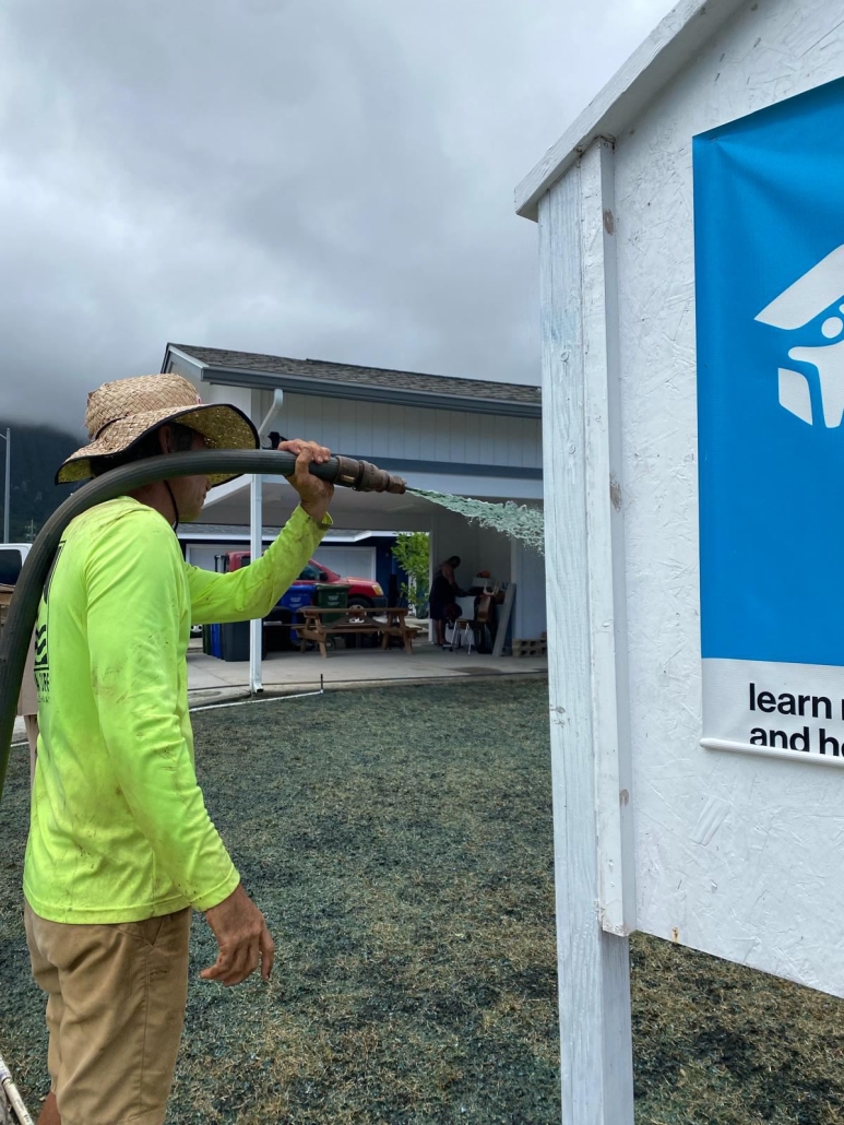 Big Island landscaper sprays lawn with Hydroseed mixture.