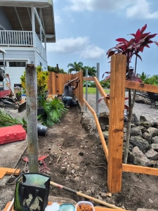 Kailua-Kona fence builder in Hawaii installs wood fence panels to railing. Custom-designed fence with pressure-treated wood.