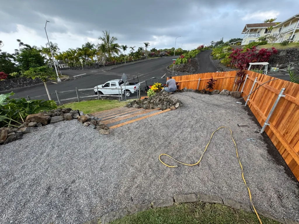 Landscapers in Kailua-Kona add lava rock and native plants to complete Hawaiian landscape project.