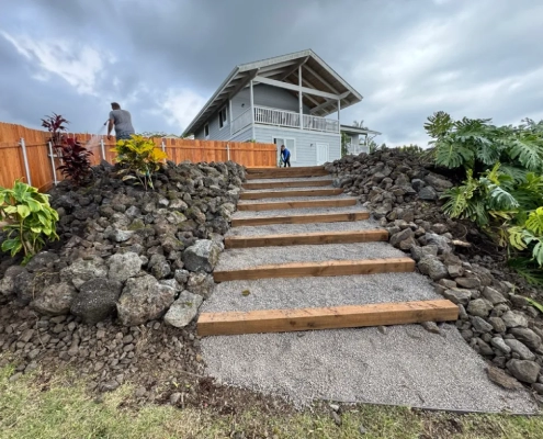 Completed pathway staircase installation with moisture-resistant wooden beams, and crushed rock aggregate.