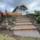 Completed pathway staircase installation with moisture-resistant wooden beams, and crushed rock aggregate.