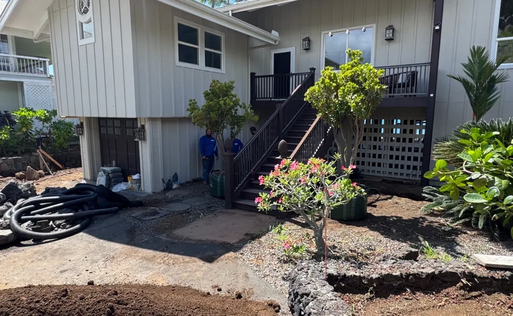 big-island-landscapers-kona Drainage pipe and materials staged at the main house entry during a Big Island landscape renovation in Kailua-Kona.