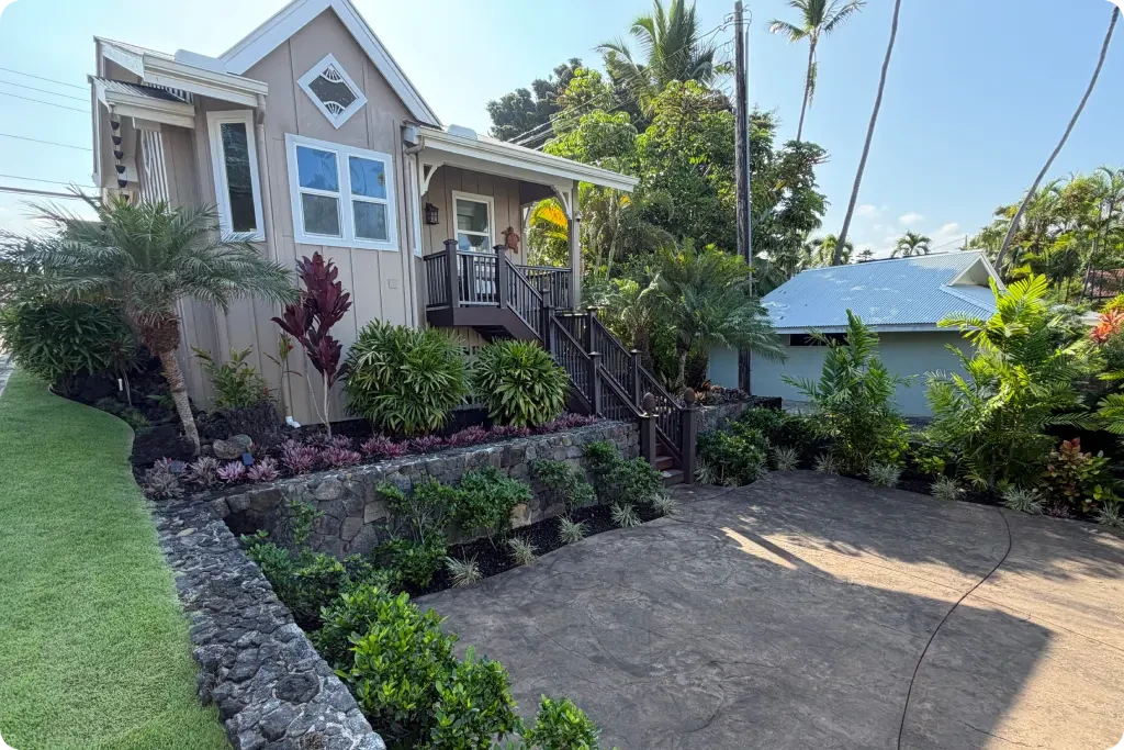 landscaping-big-island-post Completed estate landscape renovation in Kailua-Kona with restored lava rock walls, new plantings, and stamped concrete driveway at the ohana house.