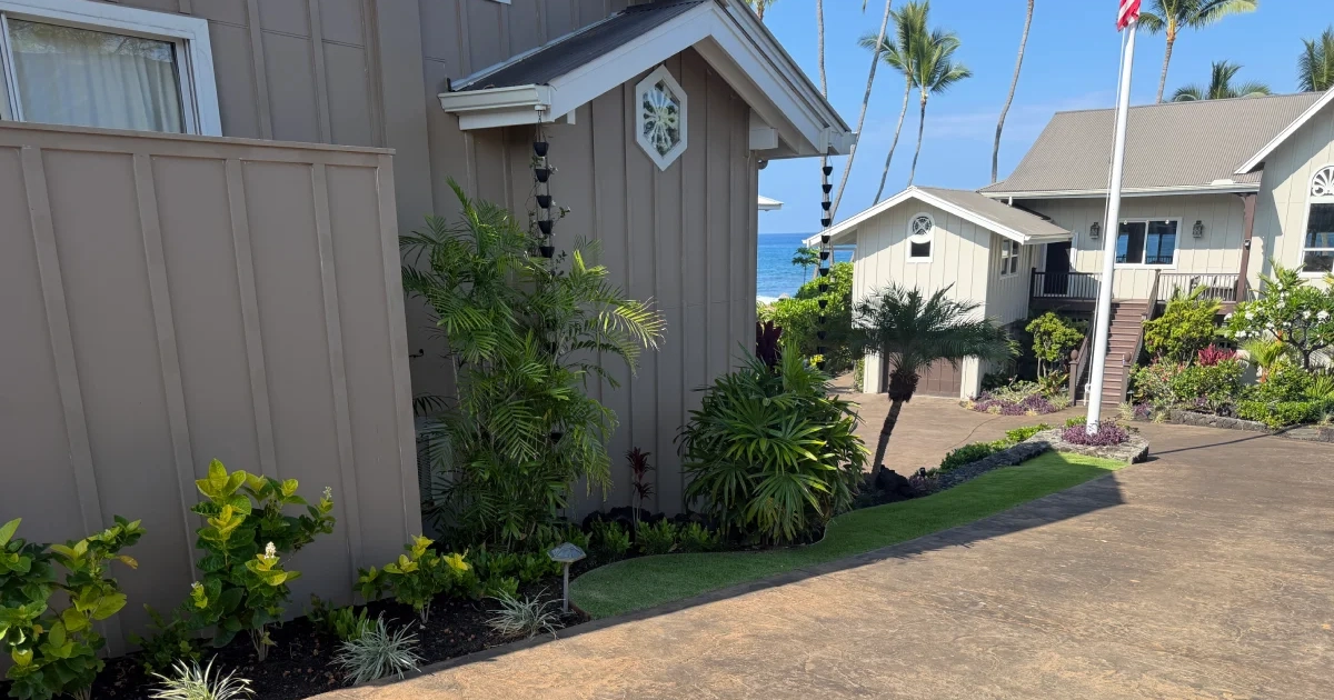 turf-and-flowerbed-after New turf and layered flowerbed beside the ohana house with the American flag and Pacific Ocean in the background, Kailua-Kona.